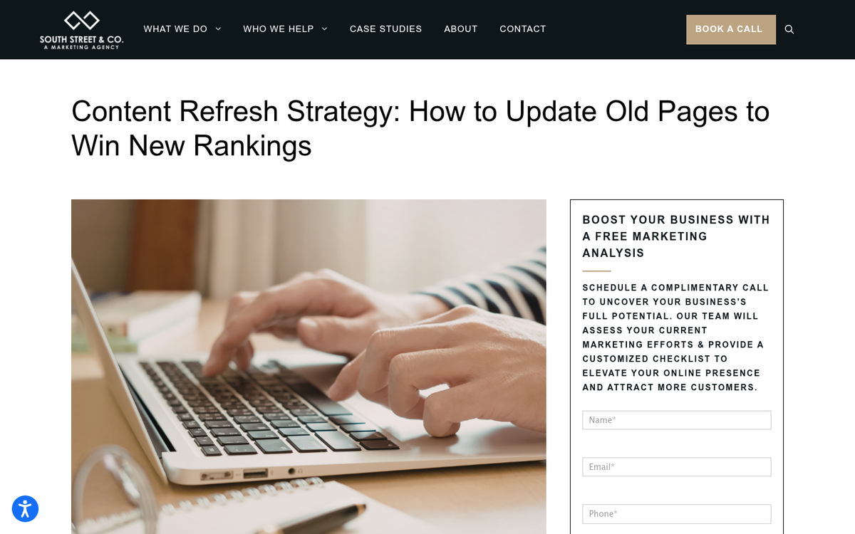 Fresh green plant growing from laptop keyboard