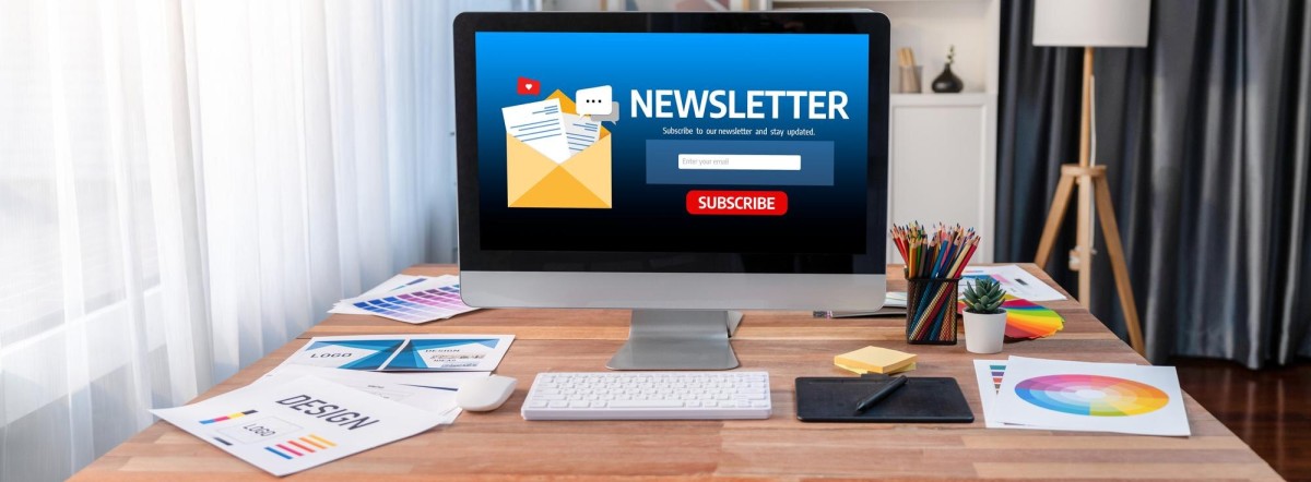 Person sending email newsletter on laptop