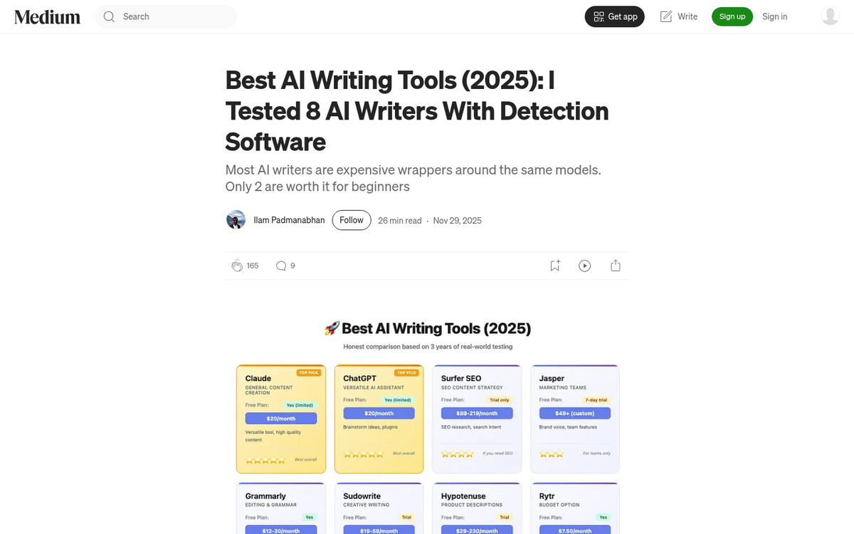 Person writing at a desk with laptop