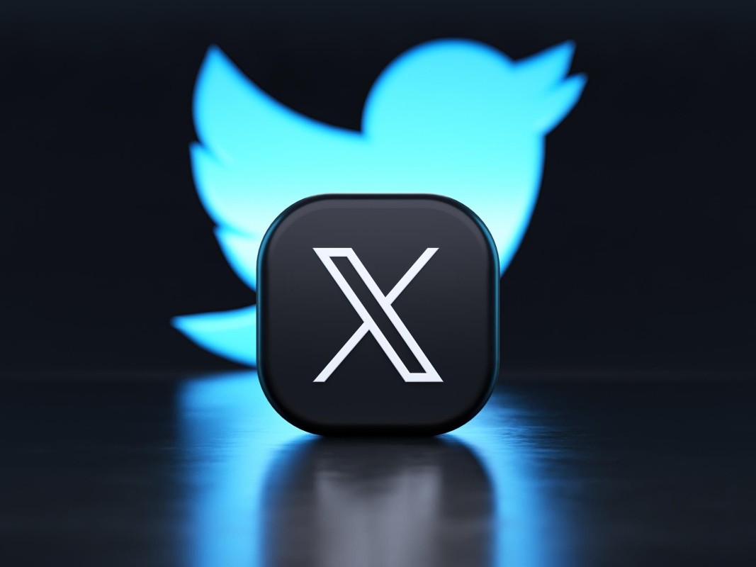Twitter X logo with warning sign overlay