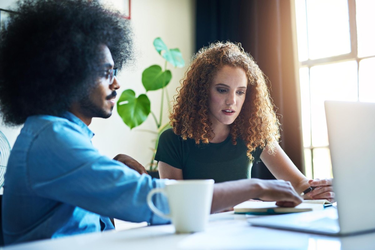Person writing thoughtfully at a desk