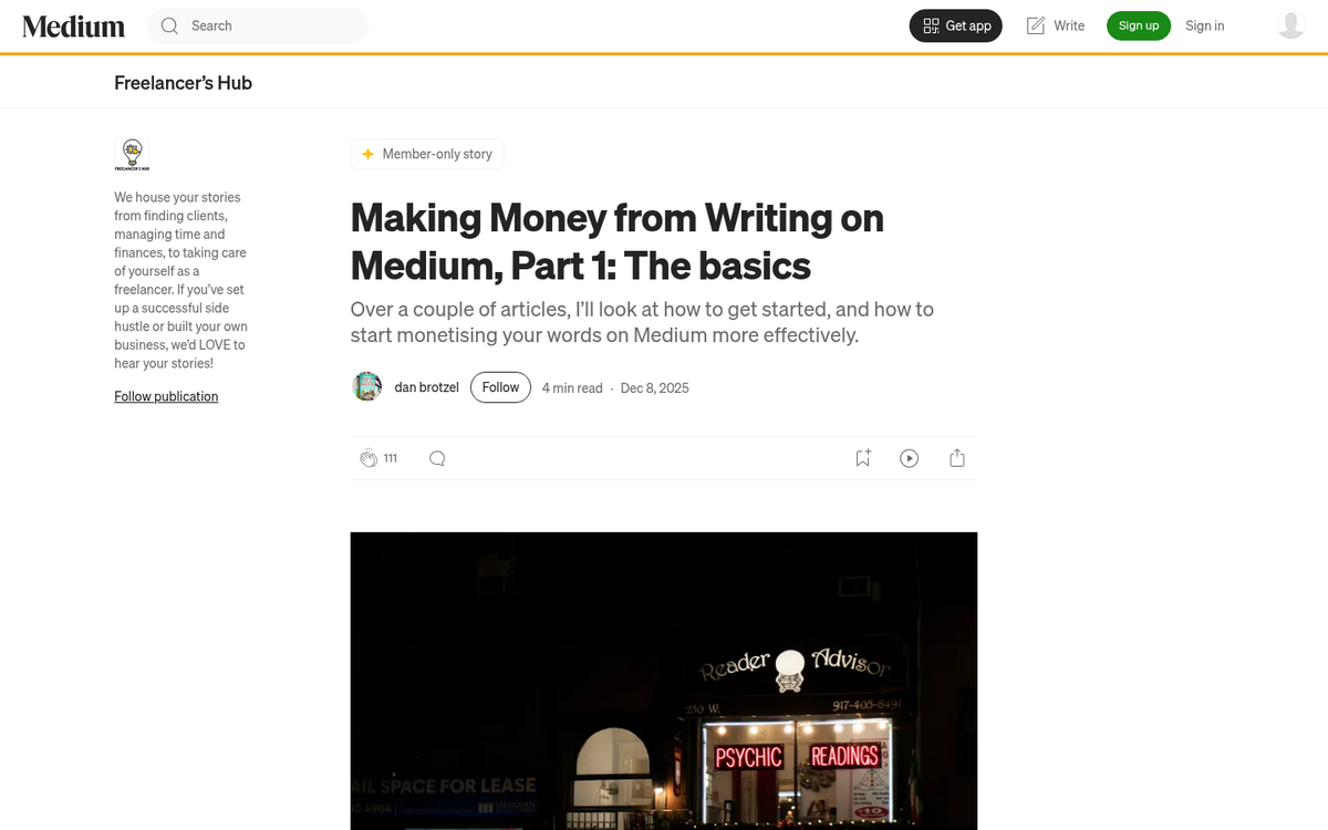 Person writing article on laptop computer