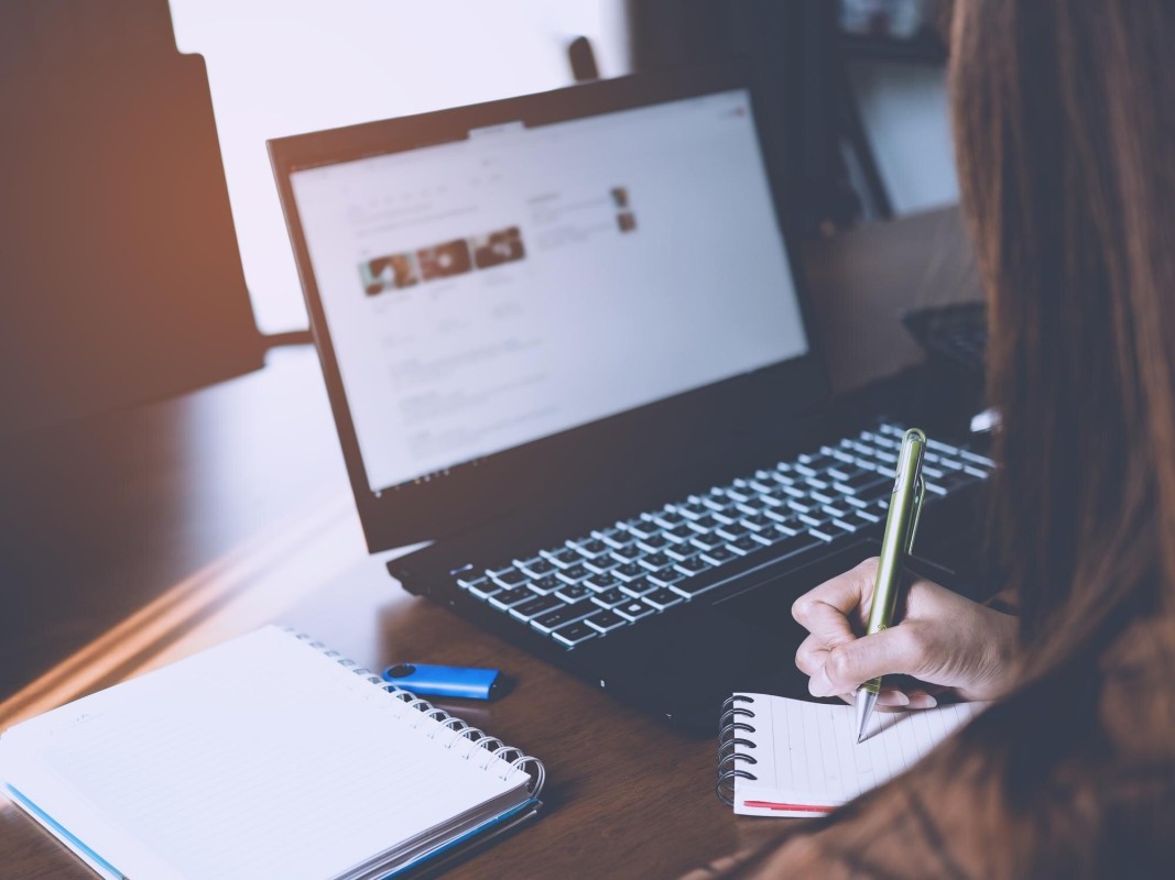 Person writing and editing advertisement copy