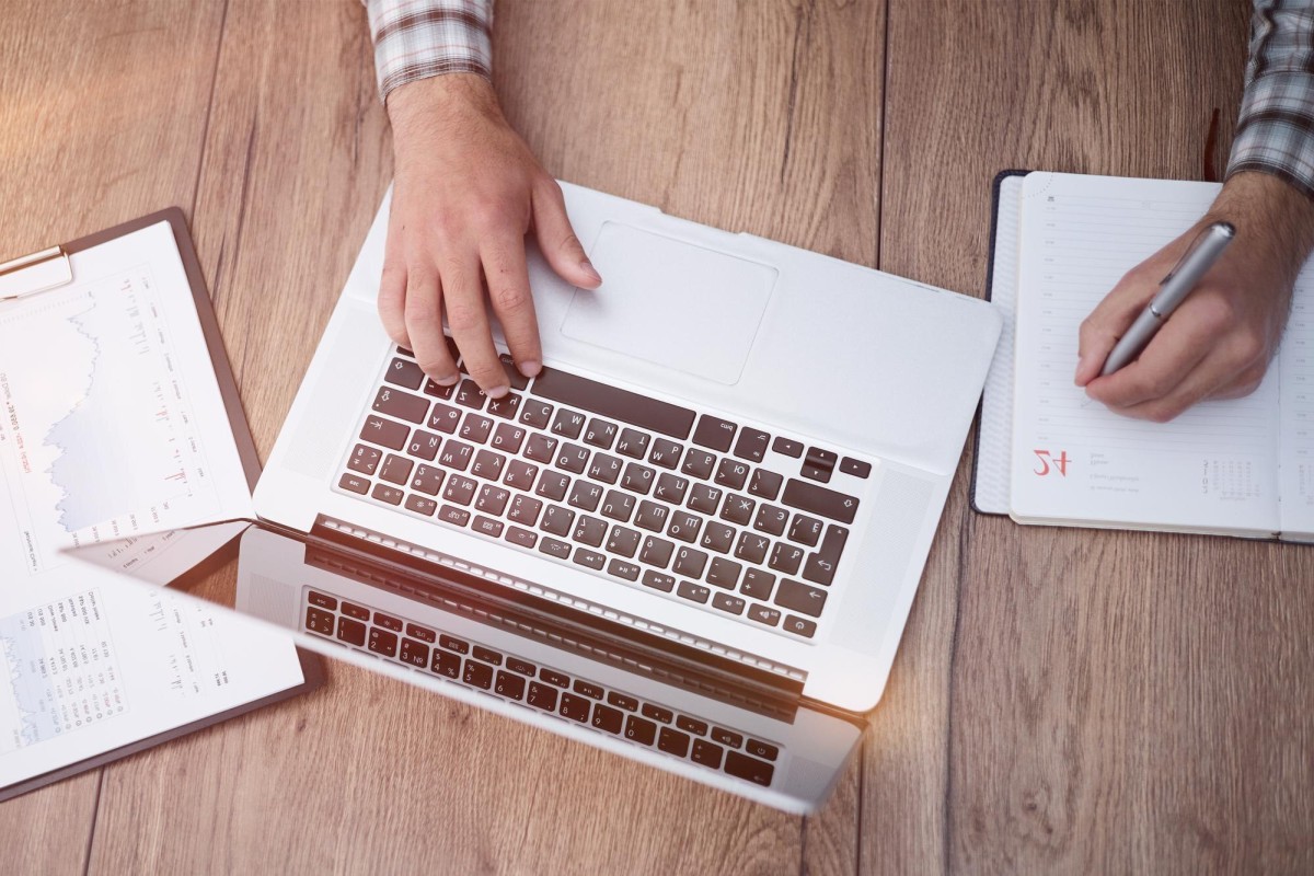 Person writing detailed tutorial on laptop
