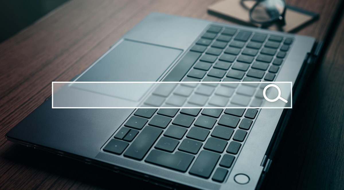 Person using keyword research tool on laptop