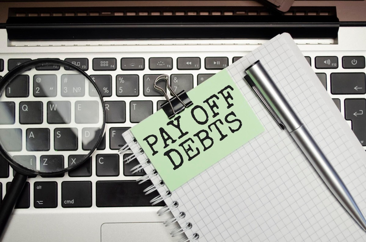 Person deleting outdated web content on laptop