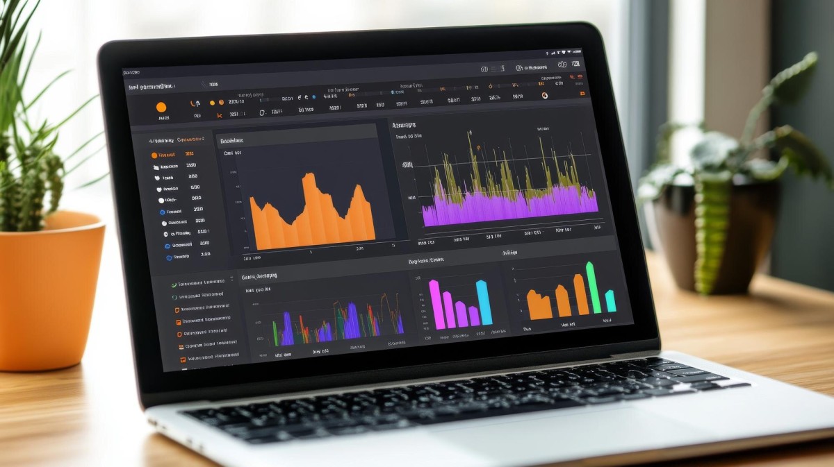 Person tracking sales data on laptop