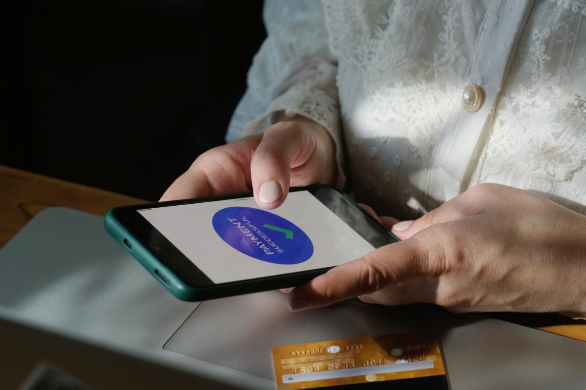 Person tapping phone for contactless payment