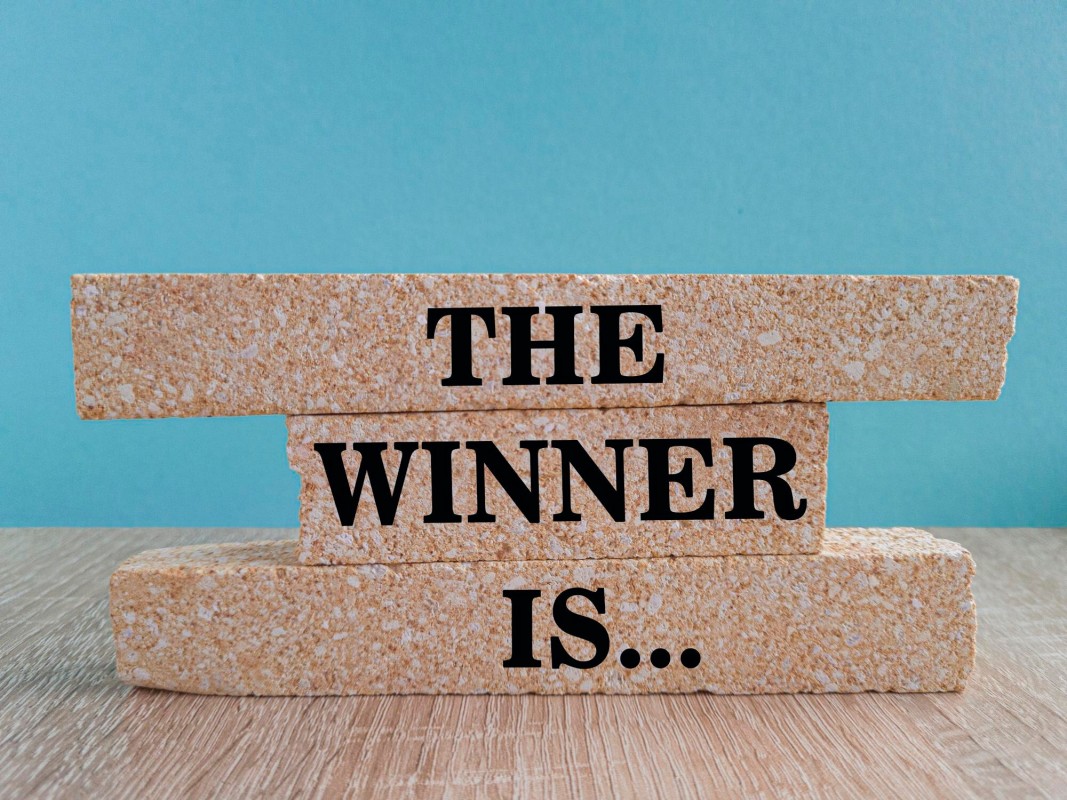 Person holding trophy winning a contest