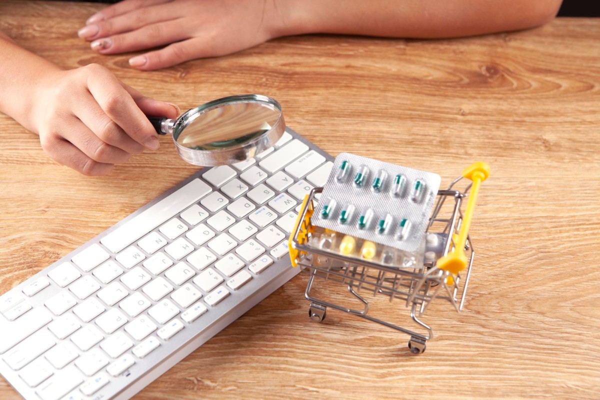 Person typing keywords on laptop keyboard