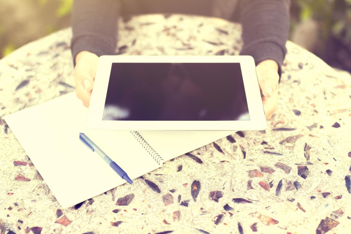 Person breaking apart a book into pieces