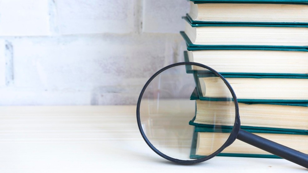 Magnifying glass examining organized content library folders